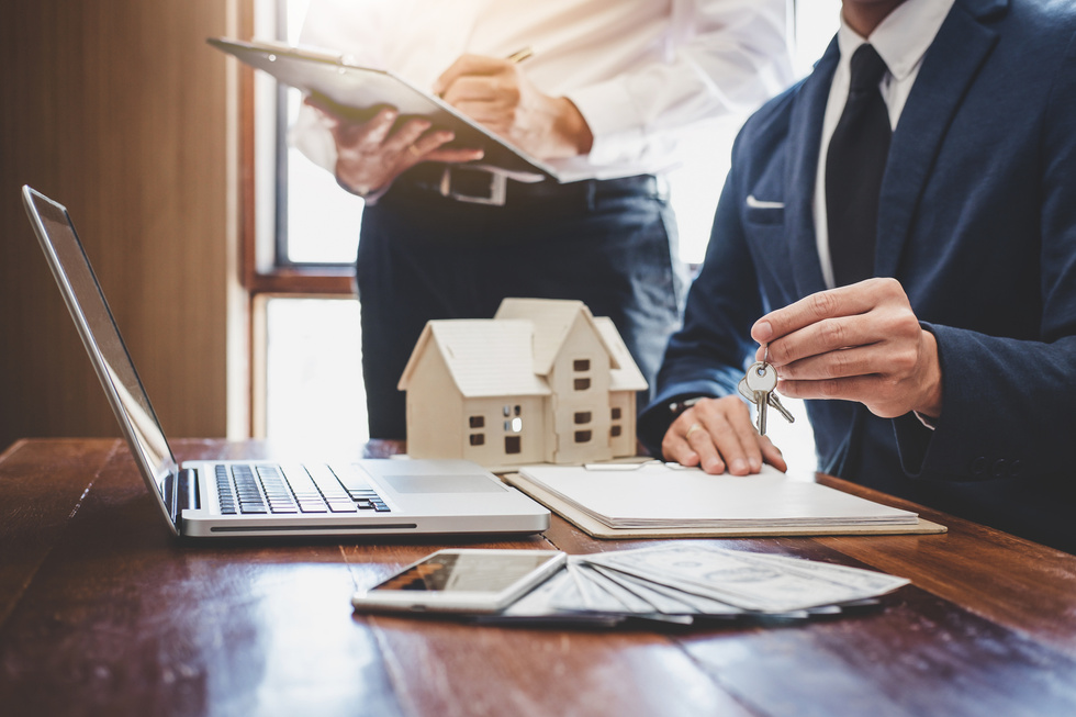 Real estate agent and Sales manager team analysis pricing of rental lease contract of sale purchase agreement, concerning mortgage loan offer for and house insurance